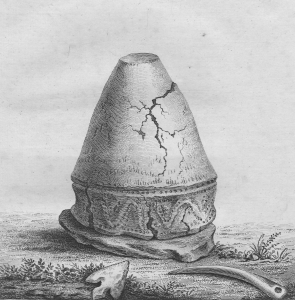 Grey scale image of upside down conical urn on a stone