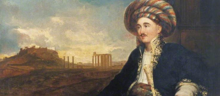Oil painting of Robert Wilson wearing a Turkish costume, tucked into the waistband of this costume is a Persian dagger and sheath (ABDUA:63523). Scroll in left hand with list of Alexander's Conquests. Background shows the Ruins of Athens (?). Painted in Rome in 1824