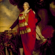 Colour photo showing an older James Duff dressed in a red cloak