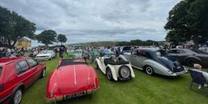 Vintage vehicles on the lawn in front of Banff Castle